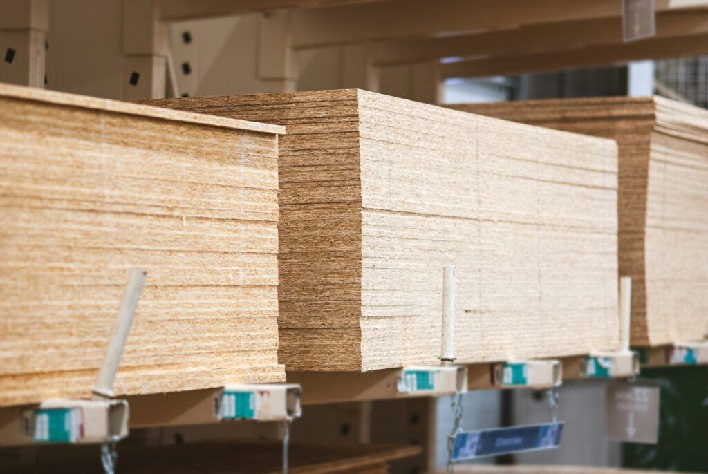 OSB boards in stock, chipboard stacked on pallets in building materials and supplies store